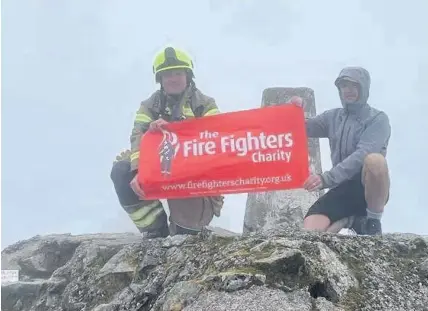  ??  ?? On top of the world Stefan Barr at the summit of Ben Nevis with pal Darren Ross