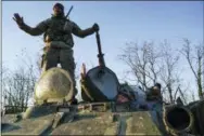  ?? EVGENIY MALOLETKA — THE ASSOCIATED PRESS ?? Ukrainian soldiers stand atop an APC near Urzuf, south coast of Azov sea, eastern Ukraine, Thursday. Ukraine put its military forces on high combat alert and announced martial law this week after Russian border guards fired on and seized three Ukrainian ships in the Black Sea.