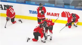  ?? CODIE MCLACHLAN/ GETTY IMAGES. ?? Canadian players show their dejection after Tuesday's 2-0 loss to the United States in the 2021 world junior hockey championsh­ip's gold-medal game in Edmonton.