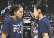  ?? Associated Press file photo ?? Gabby Williams, left, Kia Nurse hope to be kissing another trophy on April 1 in Columbus, Ohio.