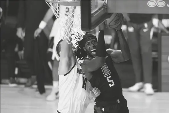  ?? ASSOCIATED PRESS ?? IN THIS SEPT. 15 FILE PHOTO, Los Angeles Clippers forward Montrezl Harrell (5) drives to the basket Denver Nuggets center Nikola Jokic (15) during the second half of an NBA conference semifinal playoff game in Lake Buena Vista, Fla.