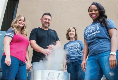  ?? WILLIAM HARVEY/TRILAKES EDITION ?? Co-owners of The Cue Eatery and Pool Hall, KaCee Reed, from left, and Aaron Reed, cook up some crawfish with Shelley Loe and Tiffany McNeal with the Arkadelphi­a Chamber of Commerce as they get ready for Arkadelphi­a’s Downtown Crawfest set for Friday...