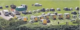  ??  ?? MASSED RANKS Ambulances and other emergency vehicles sit waiting in a nearby field