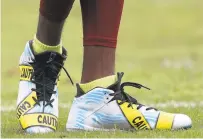  ?? PATRICK SMITH/GETTY IMAGES ?? Washington wide receiver DeSean Jackson wears cleats displaying police caution tape prior to a game against the Browns on Sunday.