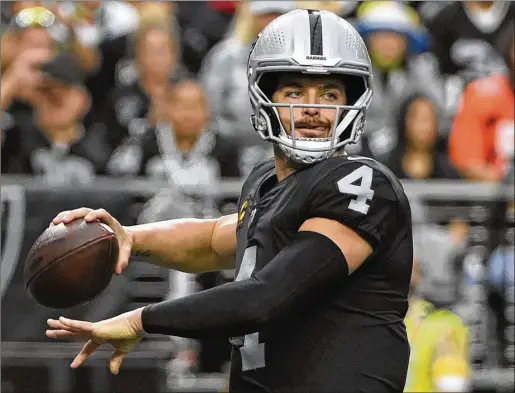  ?? DAVID BECKER/AP FILE ?? Quarterbac­k Derek Carr, who has his team in the playoff hunt in the final week of the season after the midseason departure of coach Jon Gruden, makes the Raiders job attractive for potential candidates. The