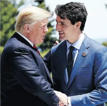  ?? LEON NEAL / GETTY IMAGES ?? Prime Minister Justin Trudeau greets U.S. President Donald Trump on Friday. Both leaders managed to share a few loaded jokes despite fears of a looming trade war.