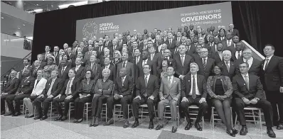  ?? AP Photo/Jose Luis Magana ?? ■ Internatio­nal Monetary Fund Governors gather Saturday for a group photo during World Bank/IMF Spring Meetings in Washington.