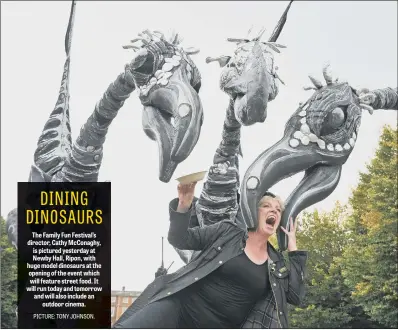  ??  ?? The Family Fun Festival’s director, Cathy McConaghy, is pictured yesterday at Newby Hall, Ripon, with huge model dinosaurs at the opening of the event which will feature street food. It will run today and tomorrow and will also include an outdoor cinema.