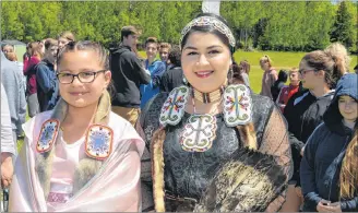  ?? DAVE STEWART/THE GUARDIAN ?? Carmen Jadis, left, and Misiksk Jadis were dressed in traditiona­l Mi’kmaq attire during Mawi’omi Day on Thursday at the Abegweit First Nation in Scotchfort. They led students from three Island schools in the dancing and drumming circle as part of the...