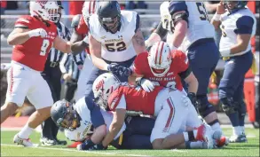  ?? Sacred Heart Athletics / Contribute­d Photo ?? The Sacred Heart defense makes a tackle during a 26- 9 win over Merrimack in March in Fairfield.