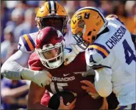  ?? The Associated Press ?? WRAPPED UP: Arkansas quarterbac­k Cole Kelley is stopped short on fourth down by LSU linebacker K’Lavon Chaisson (4) and defensive end Frank Herron during the second half of an NCAA college football game Saturday in Baton Rouge, La. LSU outscored the Hogs 26-3 in the second half to win 33-10.