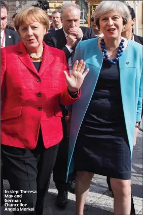  ??  ?? In step: Theresa May and German Chancellor Angela Merkel