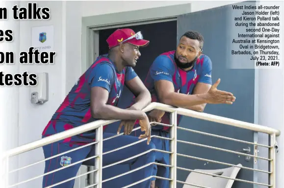  ?? (Photo: AFP) ?? West Indies all-rounder Jason Holder (left) and Kieron Pollard talk during the abandoned second One-day Internatio­nal against Australia at Kensington Oval in Bridgetown, Barbados, on Thursday, July 23, 2021.