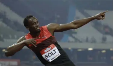  ?? MATT DUNHAM — THE ASSOCIATED PRESS ?? Usain Bolt poses for photograph­ers after he won the men’s 200 meter race during the Diamond League anniversar­y games in London on July 22.