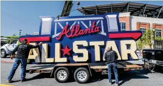 ?? JOHN SPINK/JOHN.SPINK@AJC.COM ?? Workers load the All-star sign after removing it from near the Truist Park scoreboard April 6. The sign came down after Major League Baseball pulled this year’s All-star game from Atlanta to protest Georgia’s new voting law. The Midsummer Classic will be played in Denver.