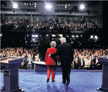  ?? Picture / AP ?? Donald Trump escorts Hillary Clinton off stage after the debate at Hofstra University, New York.