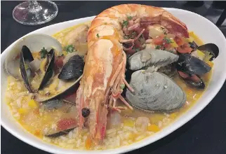  ?? PHOTOS: PETER HUM ?? Seafood and rice at Caravela, the newest Portuguese restaurant in Ottawa.