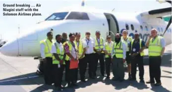  ??  ?? Ground breaking … Air Niugini staff with the Solomon Airlines plane.