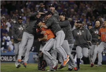  ?? AP PHOTO/MATT SLOCUM ?? The Houston Astros celebrate after Game 7 of baseball’s World Series against the Los Angeles Dodgers Wednesday in Los Angeles. The Astros won 5-1 to win the series 4-3.