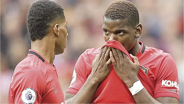  ?? AFP ?? PAUL Pogba (right) and Marcus Rashford decide on who will take the penalty shot.