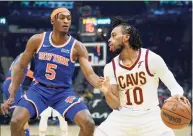  ?? Tony Dejak / Associated Press ?? The Cavaliers’ Darius Garland (10) drives against the Knicks’ Immanuel Quickley in the first half Monday in Cleveland.