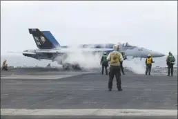  ?? AP photo ?? A F-18E fighter jet prepares to take off from USS Theodore Roosevelt aircraft carrier on Thursday, during a three-day joint naval exercise by the U.S., Japanese and South Korea at the East China Sea amid tension from China and North Korea.