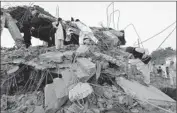  ?? Rahmat Gul
Associated Press ?? AFGHAN BOYS climb on debris of a market destroyed in a truck bombing Friday in Kabul.