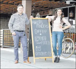  ?? DONAVON LOCKETT/LAS VEGAS REVIEW-JOURNAL ?? Makers & Finders Coffee co-owners Josh Molina and Valeria Varela pose for a photograph next to their sidewalk sign in downtown Las Vegas.