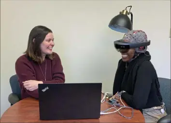  ?? Tulasi Syamala ?? Pitt researcher and assistant professor Mary Woody, left, leads research assistant Nastasia McDonald through scenarios meant to help anxious teens practice coping skills.
