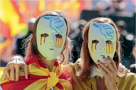  ?? PHOTO: REUTERS ?? Women wear masks during a pro-union demonstrat­ion organised by the Catalan Civil Society organisati­on in Barcelona, Spain.