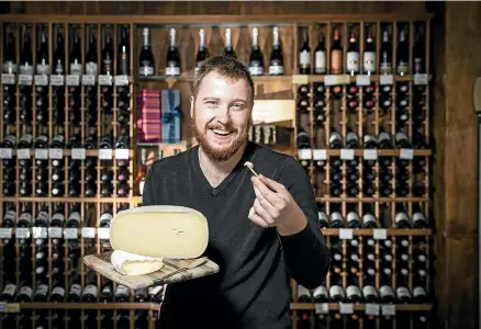  ?? BRADEN FASTIER/STUFF ?? The Junction store manager Raymond Griffith with two of their award winning cheeses, the Thorvald Curado, and the Little River Estate Brie.