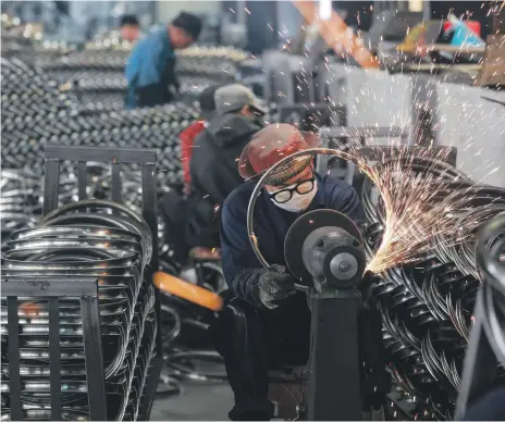  ?? AFP ?? A wheel factory in Hangzhou. The country’s manufactur­ing industry grew by 27.3 per cent from a year ago