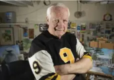  ??  ?? Joe Zuger, 75, poses at his Hamilton home (above, and left with his paintings). In 1962, Zuger threw for eight TDs in a single game against Saskatchew­an.