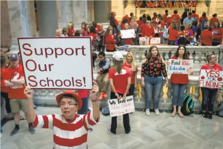  ?? Bryan Woolston / Associated Press ?? Karen Schwartz, a teacher from Louisville, rallies with other educators Friday at the state House chamber in Frankfort, Ky.