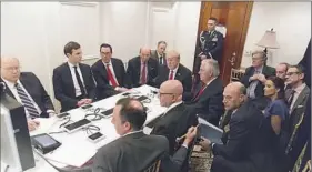  ?? White House via AP ?? In this photo provided by the White House, President Donald Trump receives a briefing from his national security team on the military strike against Syria on Thursday night at Mar-a-Lago in Palm Beach, Fla.