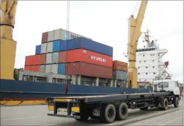  ?? NGOUN SOVANN ?? A truck loads shipping containers at the Sihanoukvi­lle Autonomous Port in September 2008. The port provides a direct route for Cambodian exports into China.