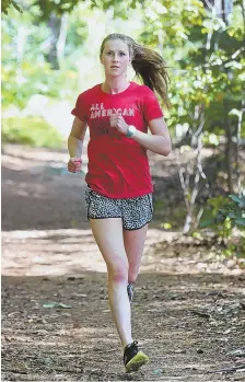  ?? STAFF PHOTO BY NANCY LANE ?? ALONE TIME: Natick’s Grace Connolly, who cruised to the Div. 1 cross country state championsh­ip last fall, takes to the trails as she prepares to defend her title.