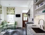  ?? ANGIE SECKINGER/MARIKA MEYER INTERIORS VIA AP ?? This photo provided by Marika Meyer Interiors shows a kitchen in Washington, D.C. Shades of blue were popular in 2018, says designer Marika Meyer, but she sees a growing trend toward decorating with shades of green, as seen in this Washington, D.C. area breakfast nook designed by Meyer in a kitchen by Aidan Design.