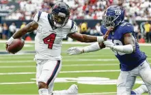  ?? Brett Coomer / Staff photograph­er ?? Texans quarterbac­k Deshaun Watson has been taking a high number of hits, including by Giants linebacker Lorenzo Carter.