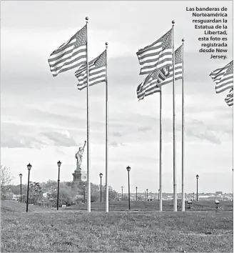  ?? ?? Las banderas de Norteaméri­ca resguardan la Estatua de la Libertad, esta foto es registrada desde New Jersey.