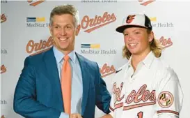  ?? LLOYD FOX/BALTIMORE SUN ?? When executive vice president and general manager Mike Elias, left, and the Orioles welcomed No. 1 overall draft pick Jackson Holliday to Baltimore on Wednesday, they added a player who they hope will add to their foundation, not begin it.