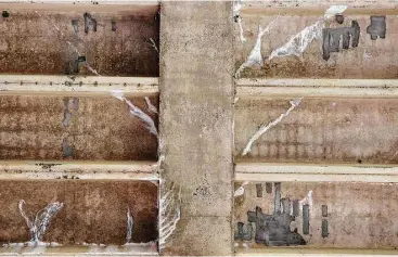  ?? Elizabeth Conley / Houston Chronicle ?? White spots are evident where water has leached through the concrete because of roof damage caused by Hurricane Ike at the College of the Mainland in Texas City. The community college has been unable to pay for repairs without the $3.94 million it’s...