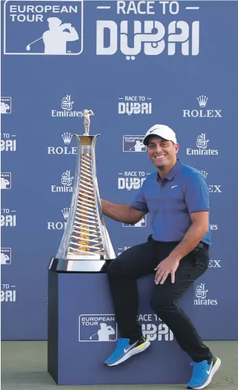  ??  ?? Francesco Molinari celebrates with the Race to Dubai Trophy after the final round of the DP World Tour Championsh­ip at Jumeirah Golf Estates in Dubai yesterday