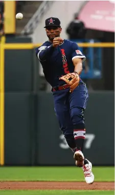  ?? THe denver post; BeloW, ap ?? LOCAL FLAVOR: American League shortstop Xander Bogaerts throws to first for an out during the All-Star Game at Coors Field in Denver on Tuesday night. Below, AL pitcher Nathan Eovaldi throws during the fourth inning.