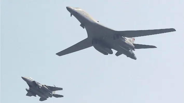  ?? AP ?? Advertenci­a. Un bombardero supersónic­o B-1B de Estados Unidos, en primer plano, pasa sobre la base de Pyeongtaek, en Corea del Sur, acompañado de cerca por un jet caza.