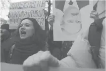  ??  ?? NEVER ENDING PROTESTS This photo taken on March 15, 2017 shows Belarusian opposition supporters with an upside down portrait of President Alexander Lukashenko taking part in a rally against a Soviet-style “tax on spongers” in Minsk.