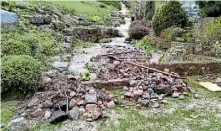  ?? ?? Rocks and debris were swept downhill in the torrent.