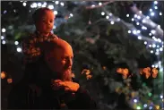  ?? BEA AHBECK/NEWS-SENTINEL FILE PHOTOGRAPH ?? Carson Castelanel­li sits on dad C.J.’s shoulders during the 2015 Zoo Lights at Micke Grove Zoo.