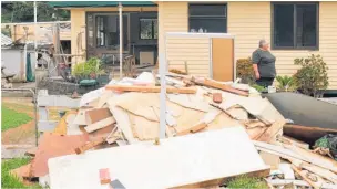  ??  ?? Contractor­s are still pulling flooddamag­ed Gib board, timber and insulation out of the Retis’ Waikare Valley home.