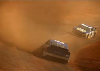  ?? Jared C. Tilton/Getty Images ?? J.J. Yeley, driver of the No. 53 Chevrolet, spins in front of Chase Elliott, driver of the No. 9 Chevrolet, during practice Friday on the dirt at Bristol Motor Speedway.